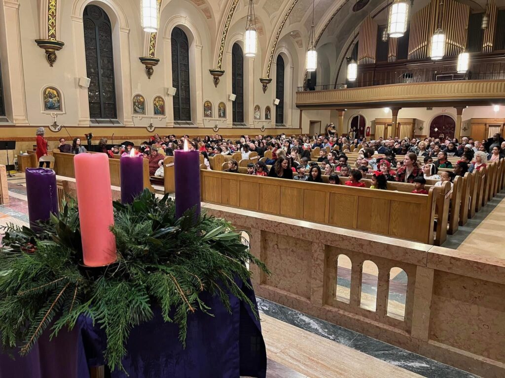 The school community at Mass with the Advent wreath