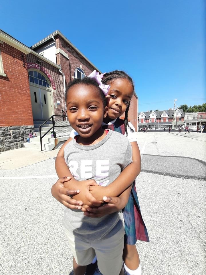 A young Resurrection student outside the school