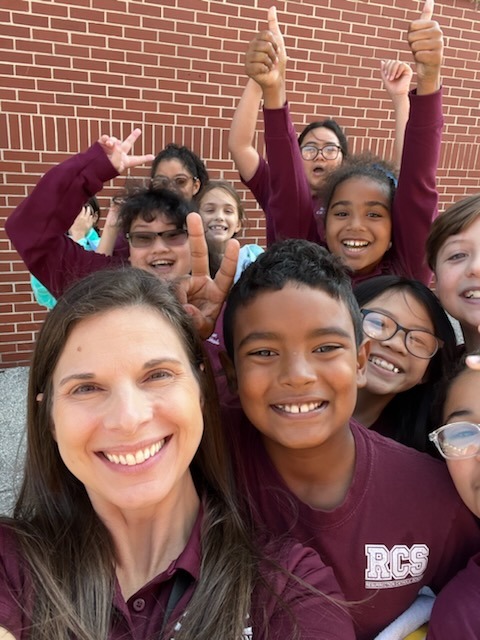 A teacher and her class celebrating together